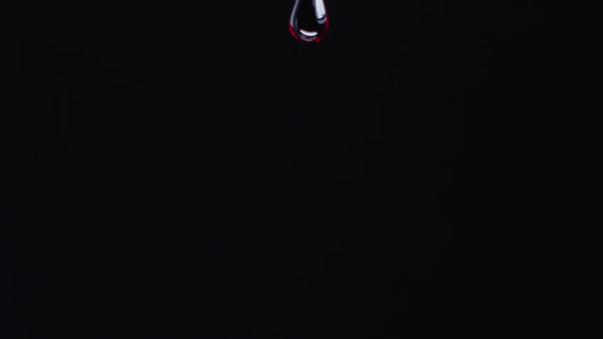A drop of red liquid falls