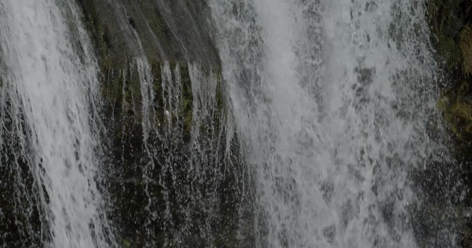 A large waterfall is flowing down