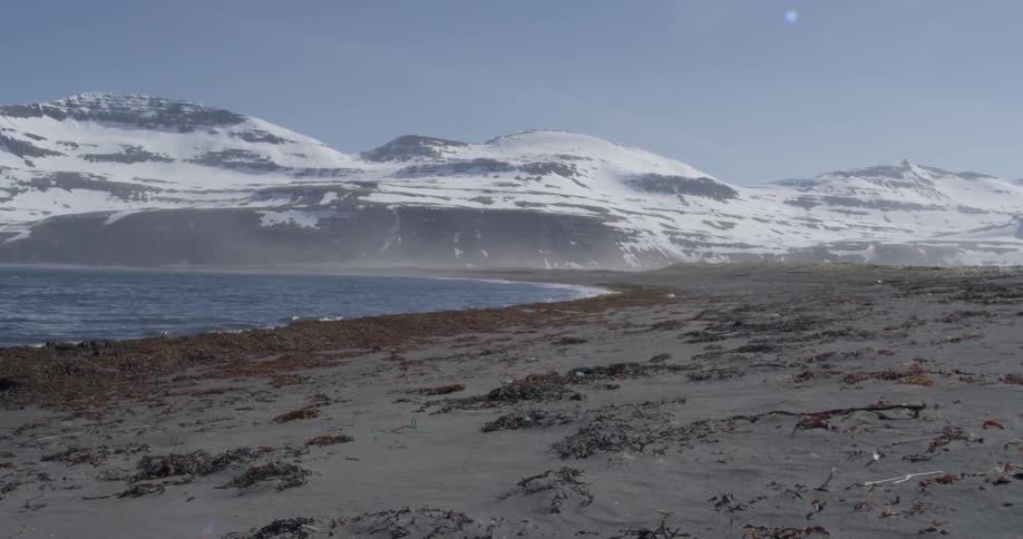 Snowy mountains surround a lake