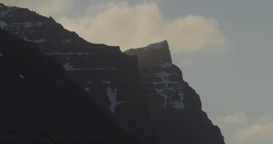 Snow dusted cliff at sunset