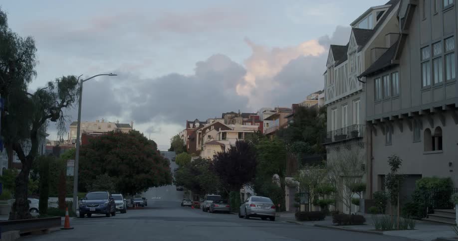 Clouds are hovering over a neighborhood at dusk