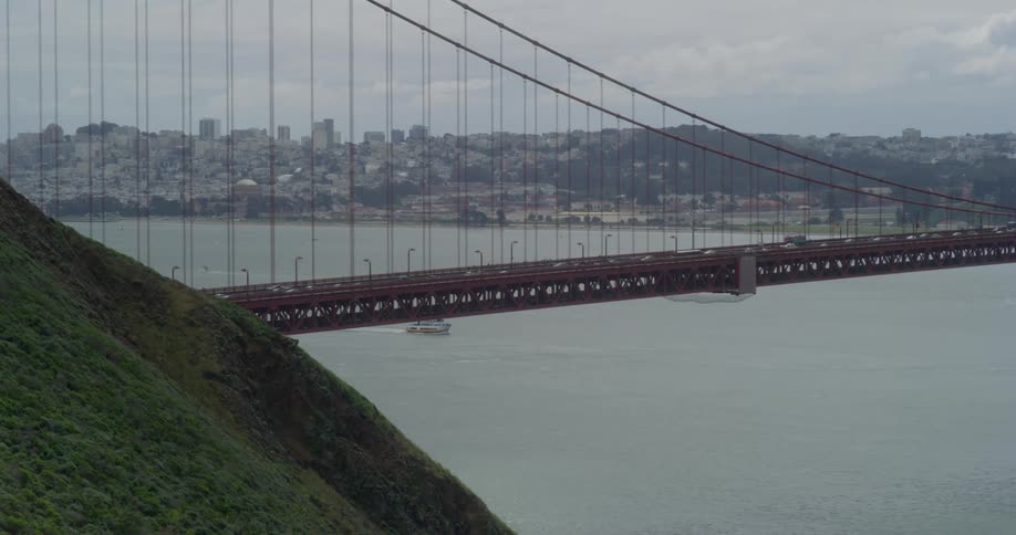Traffic travels across the golden gate bridge into San Francisco