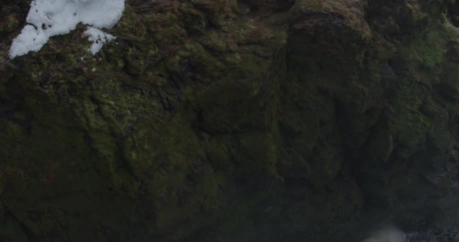 A cliff side with snow on top