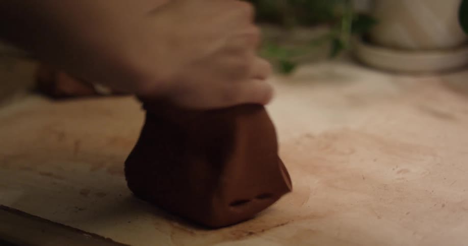 Someone is rolling and forming clay