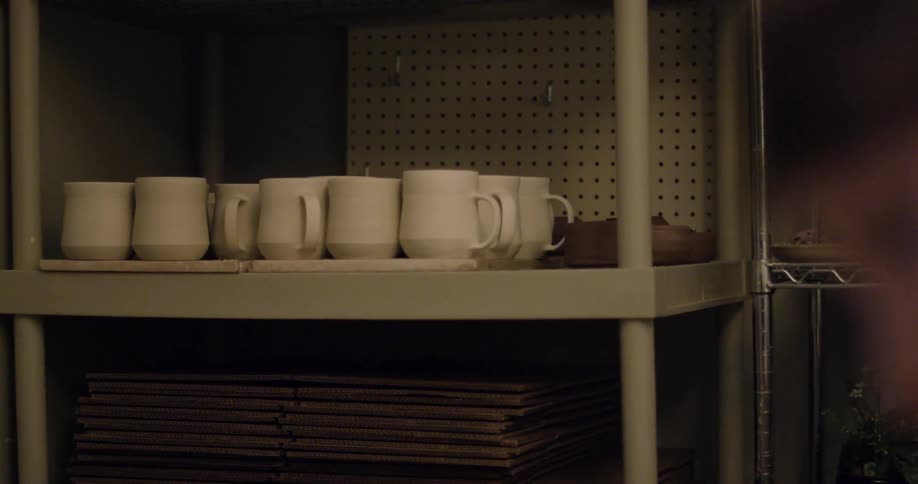 White cups on a shelf