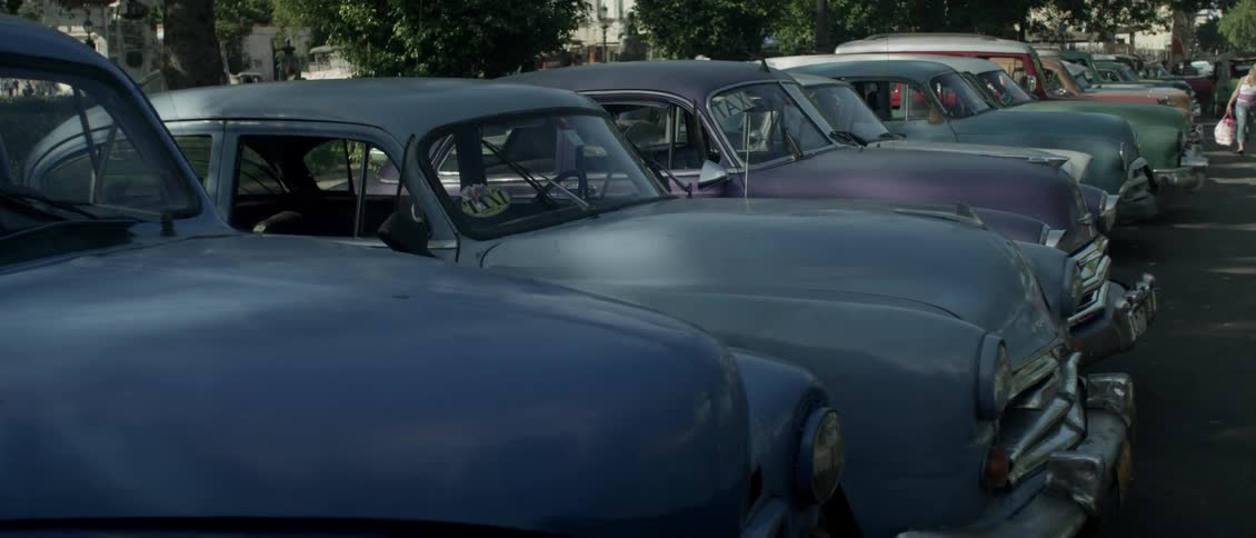 Old cars are lined up in a row