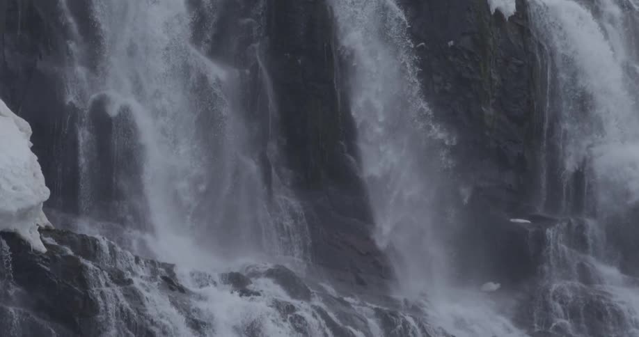 A large amount of water slowly moving downhill and over some rocks