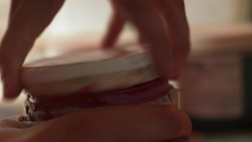 Someone is opening a jar of pink paint