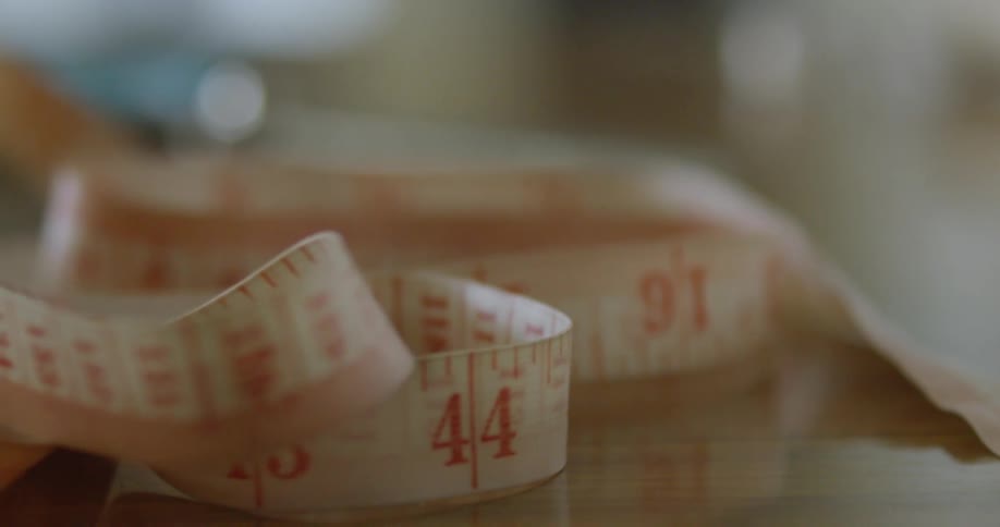 Measuring tape sits undisturbed on a table