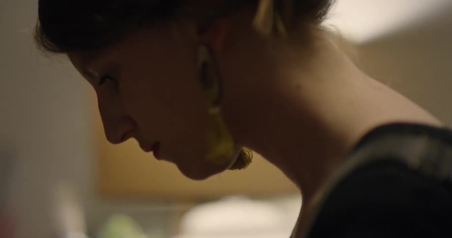 A woman is concentrating as she works during the day