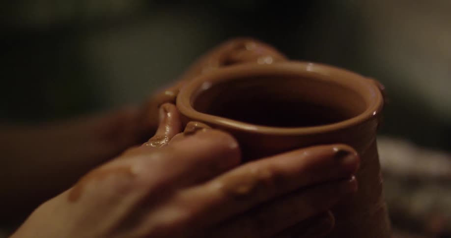 Someone is making a clay cup