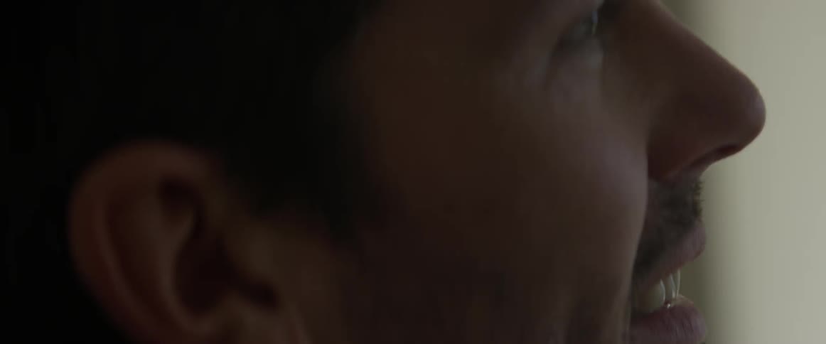 A man is laughing at something off screen
