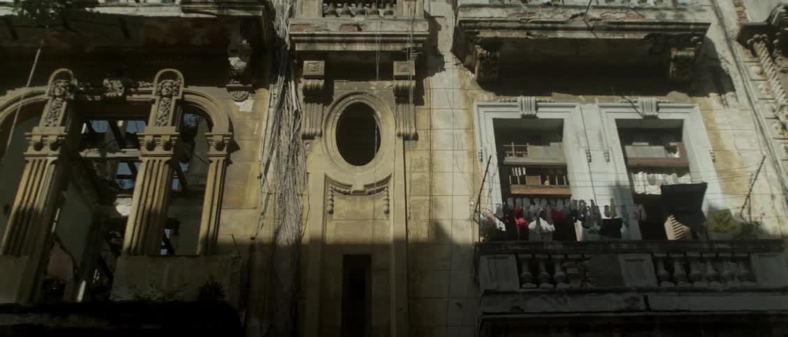 A view of a ornate building with the sun shining on parts of it