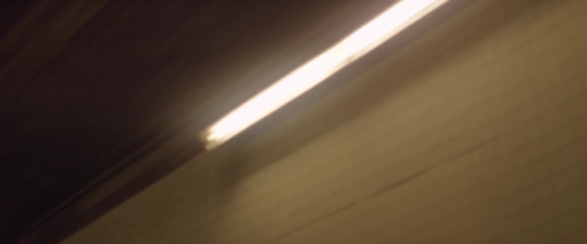 A car drives through a tunnel at night