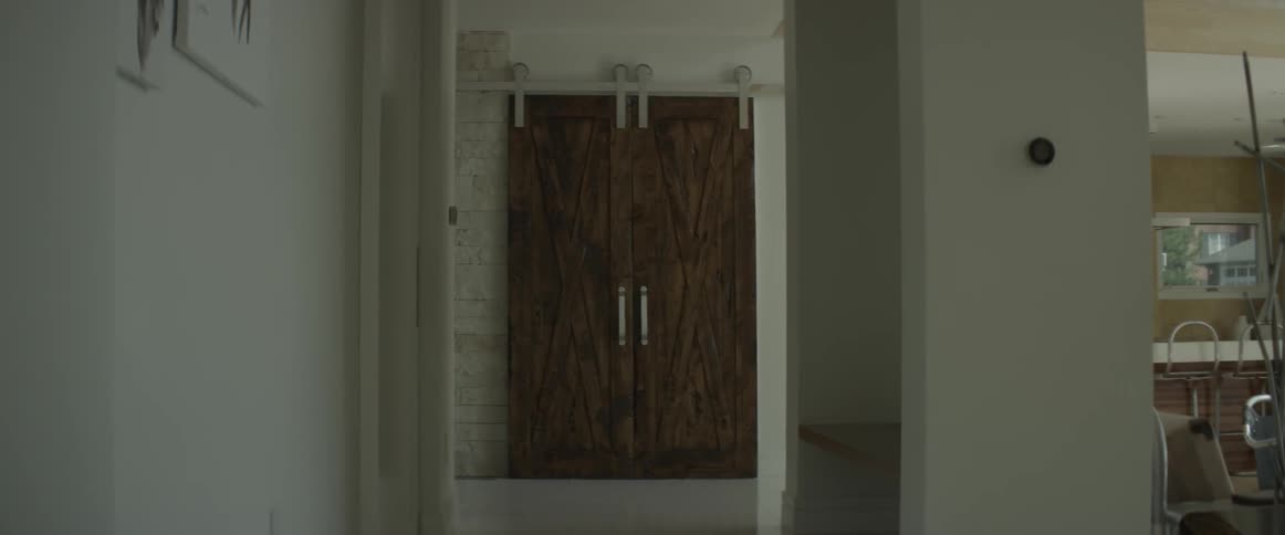 Man walking past a doorway indoors
