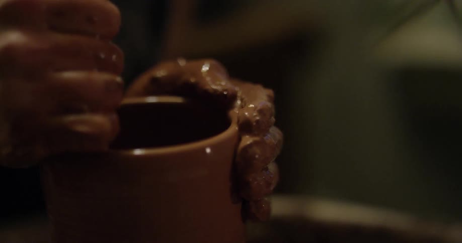 Someone is making a pot out of clay