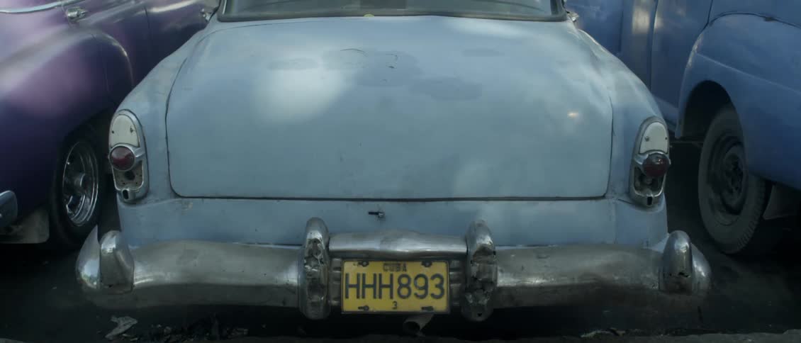 Shadows are playing on the boot of an old car in cuba during the day