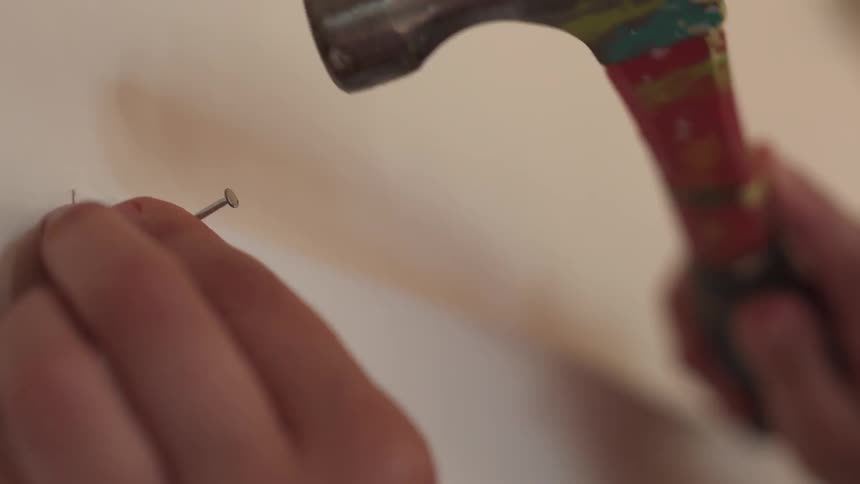 Someone is hammering a nail into the wall