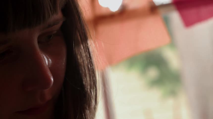 A woman is looking at something and smiling