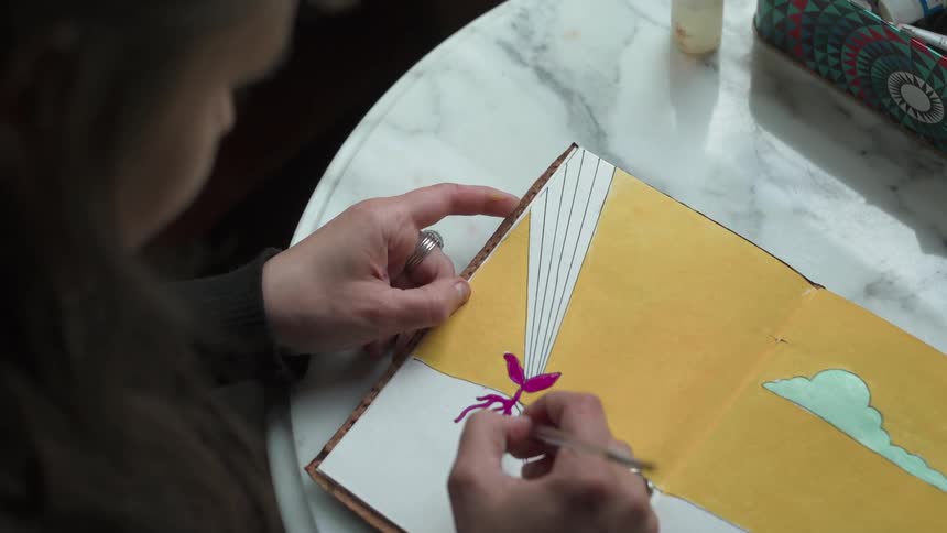 A woman is drawing a picture