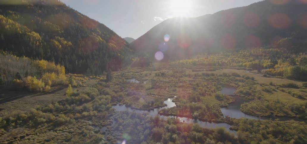 Sunlight shines over a mountain lake