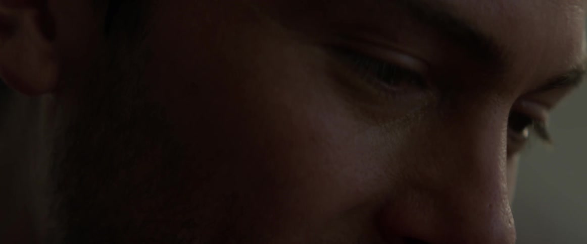 A man smiles while thinking
