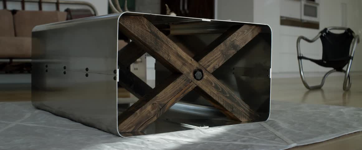 A man walks past a metal table