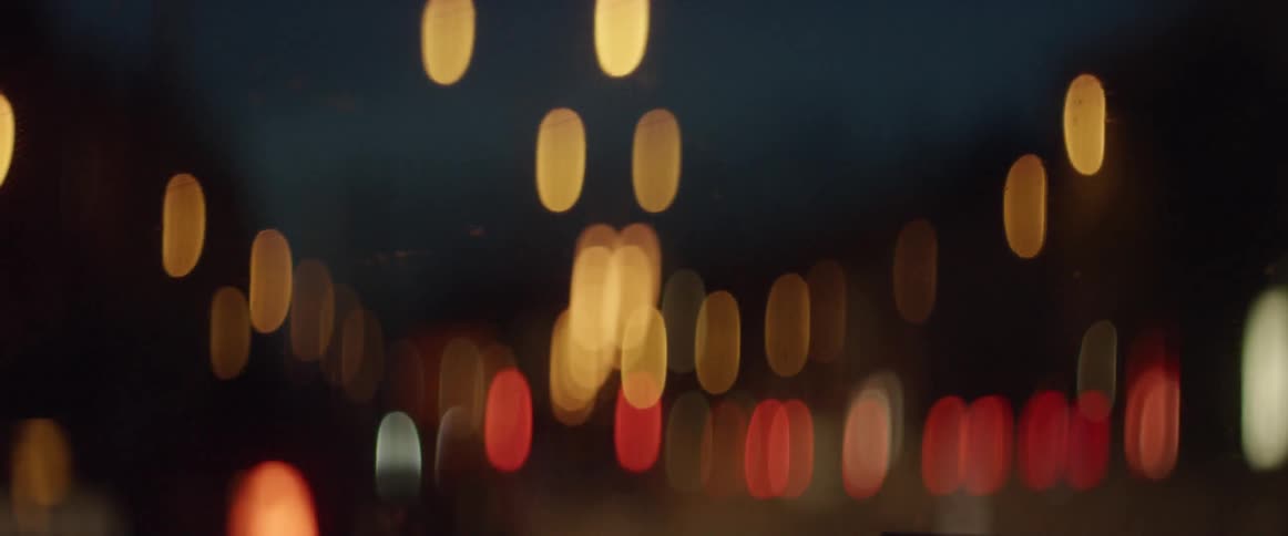 Lights from moving traffic blur at night