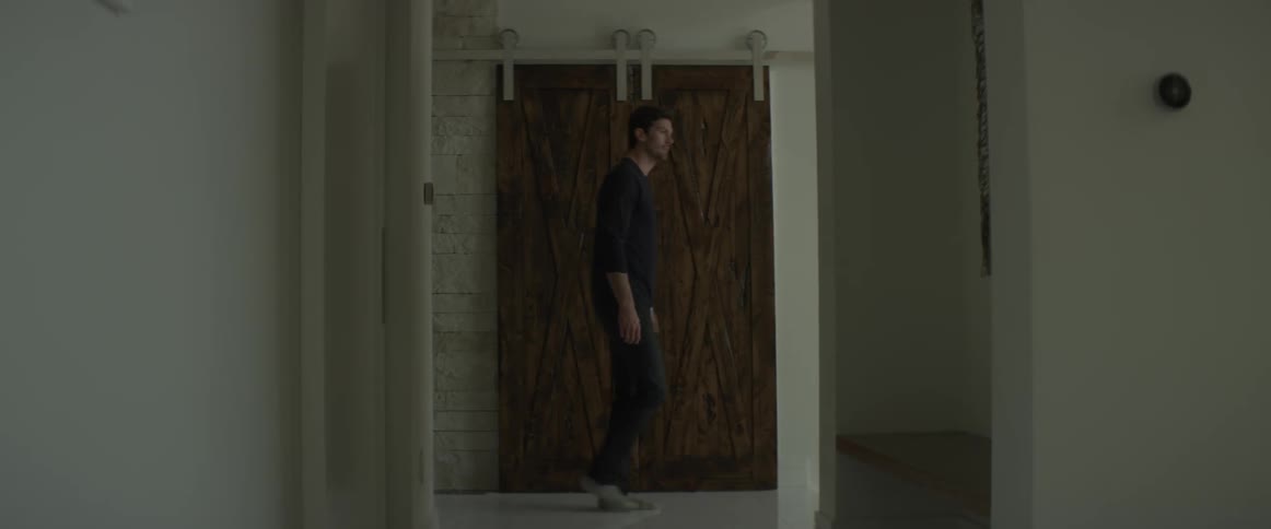 A man walks down the hall ahead