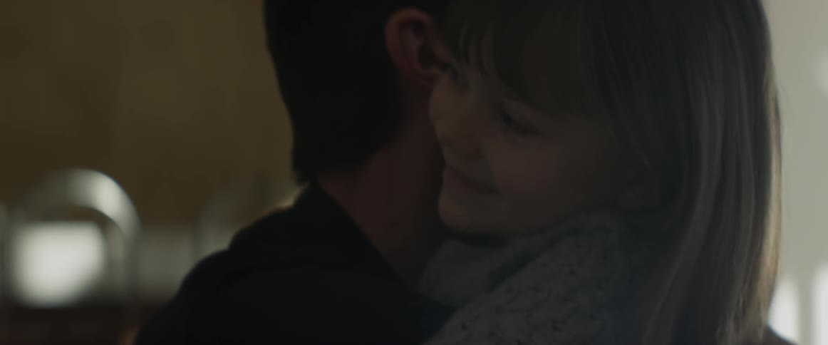 A man hugs a little girl