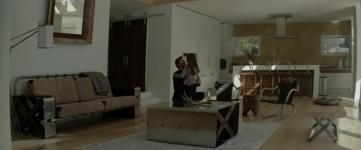 Man hugs girl in living room