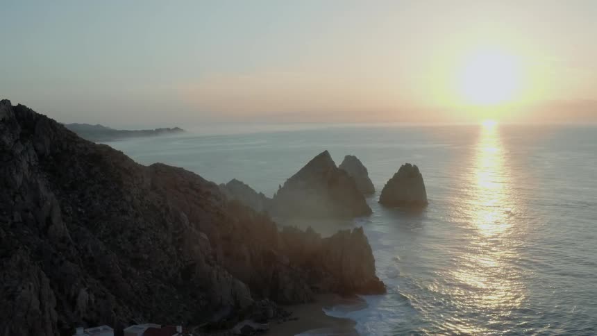 Rock formations in and near the sea at sunset