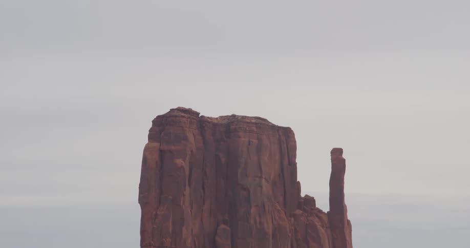 A rock formation stands tall in the desert