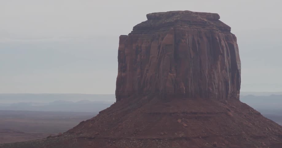A rock formation stands tall in the desert