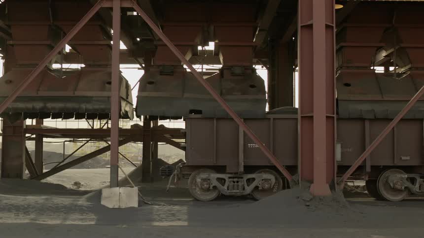 The train slowly enters the station in the desert