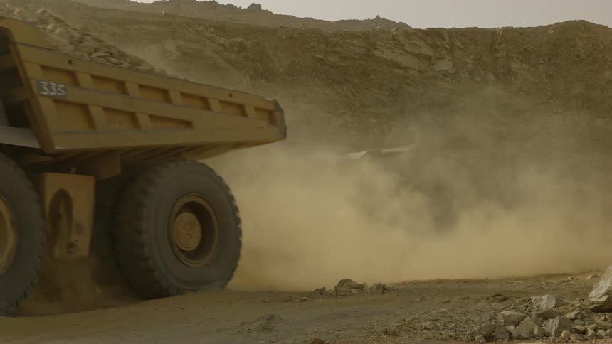 The trucks move along the work site