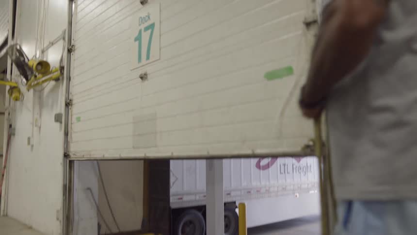 Man closes a door in a warehouse