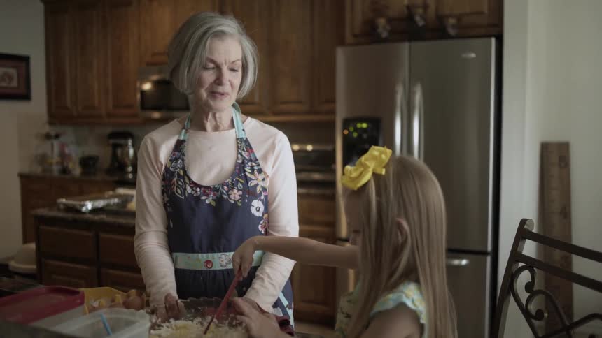 A grandmother and daughter baking in the kitchen