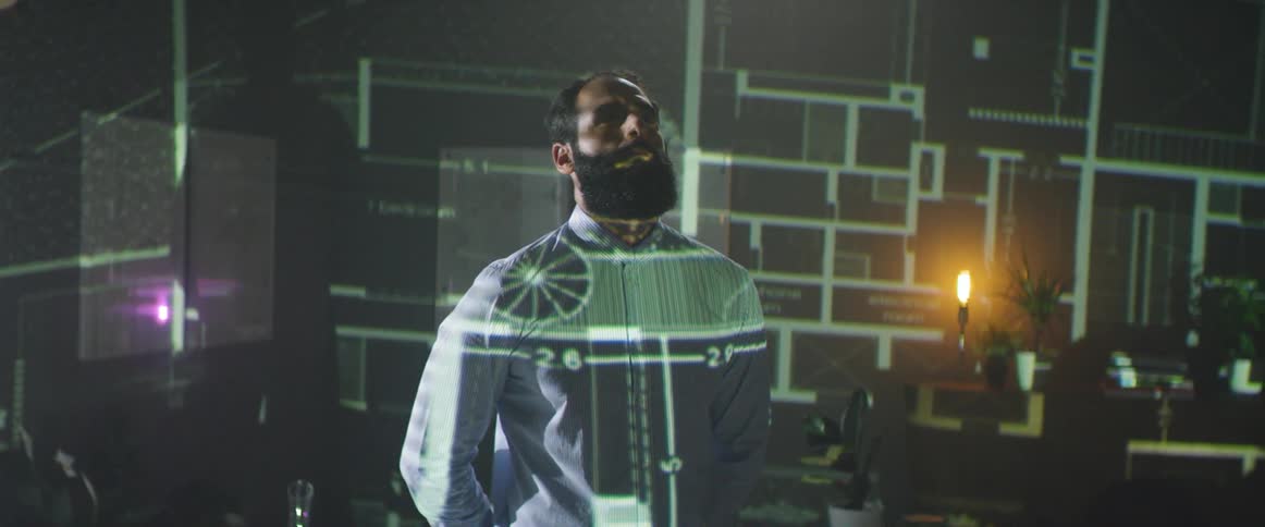A man is standing in front of flashing diagrams