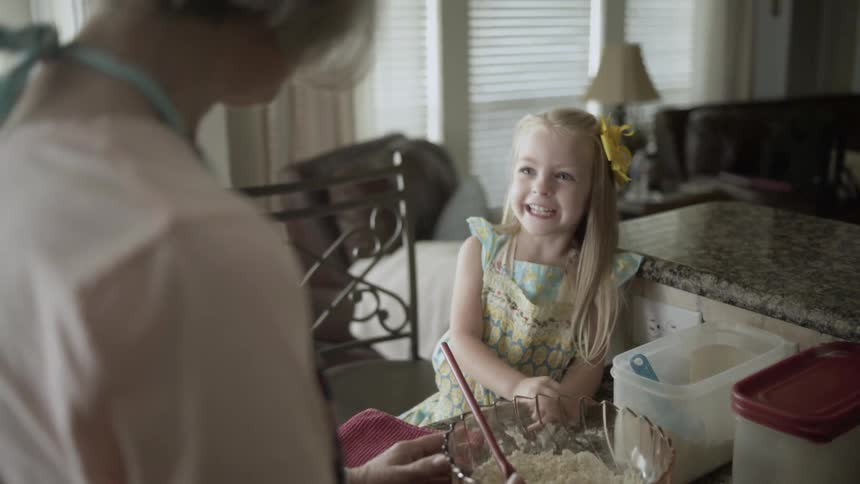 Woman and little girl talking in the kitchen