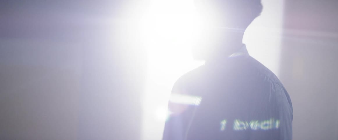 A man with a beard has a jacket that is lighting up