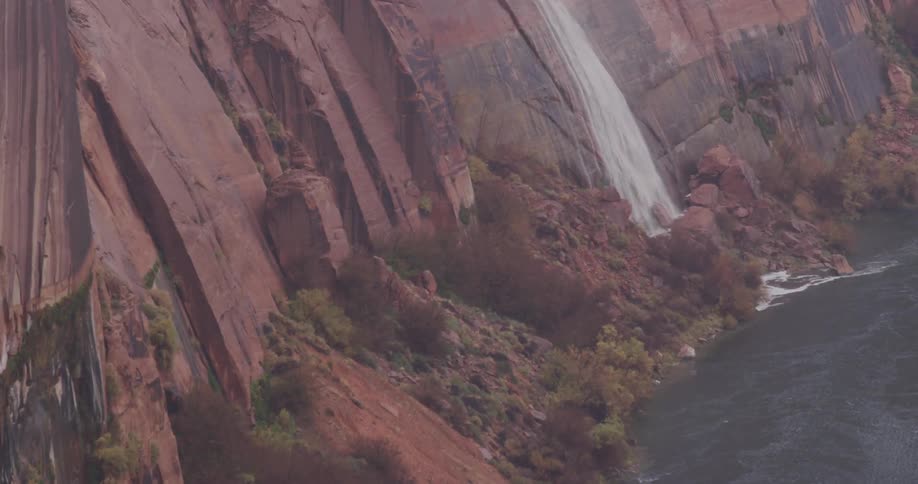 A lake sits at the base of a cliff