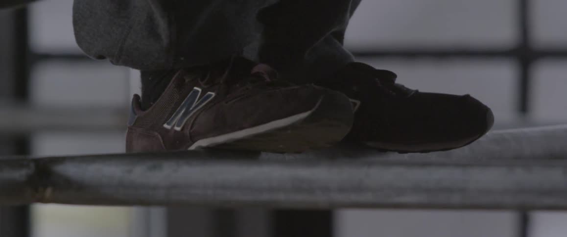 Close up of the feet of someone jumping onto a rail
