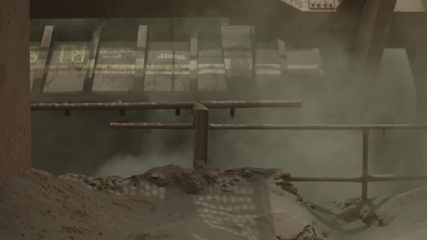 A machine is turning dirt in the work site