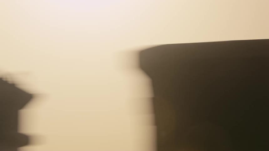 A train is passing by on a dusty day