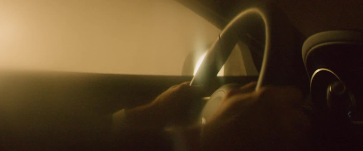 Man drives a car through a smoky area