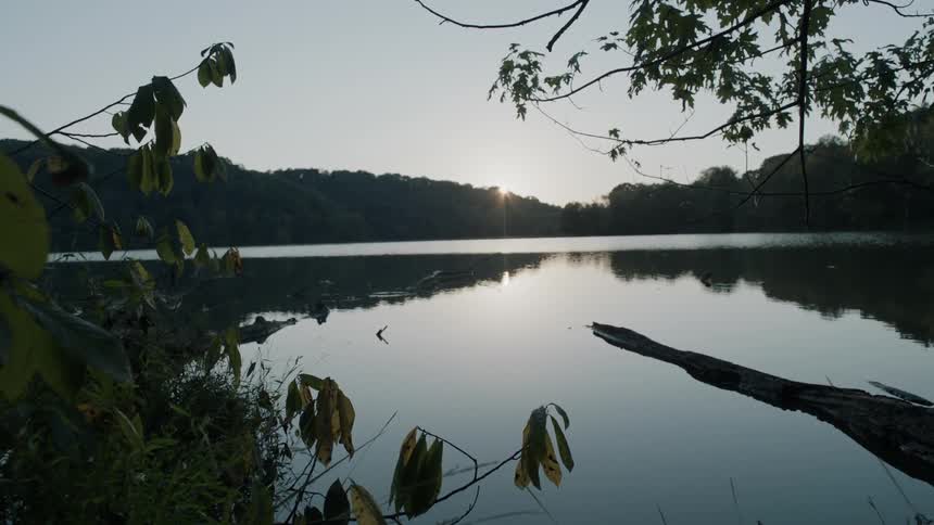 The sun sets over a mountain lake
