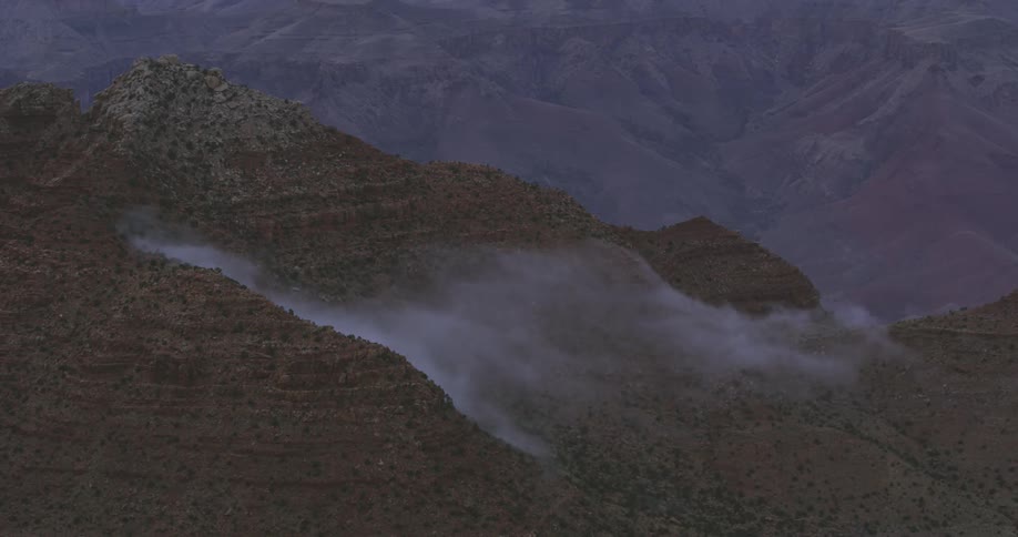 Time lapse of clouds dissipating from a mountain side