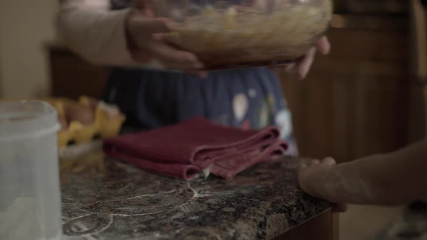 Girl mixes a bowl of batter in a kitchen