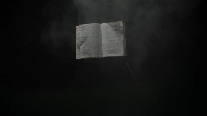Smoke floats around an open book